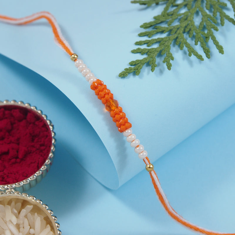 DELICATE PEARL BEADS Orange RAKHI WITH ROLI CHAWAL & RAKSHABANDHAN CARD