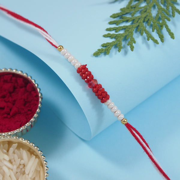 DELICATE PEARL BEADS RED RAKHI WITH ROLI CHAWAL & RAKSHABANDHAN CARD