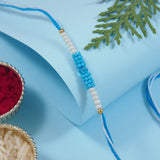 DELICATE PEARL BEADS TURQUOISE RAKHI WITH ROLI CHAWAL & RAKSHABANDHAN CARD