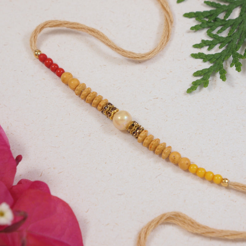 DELICATE PEARL BEADED CREAM RAKHI WITH ROLI CHAWAL & RAKSHABANDHAN CARD