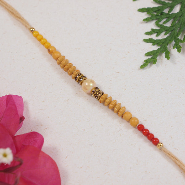 DELICATE PEARL BEADED CREAM RAKHI WITH ROLI CHAWAL & RAKSHABANDHAN CARD