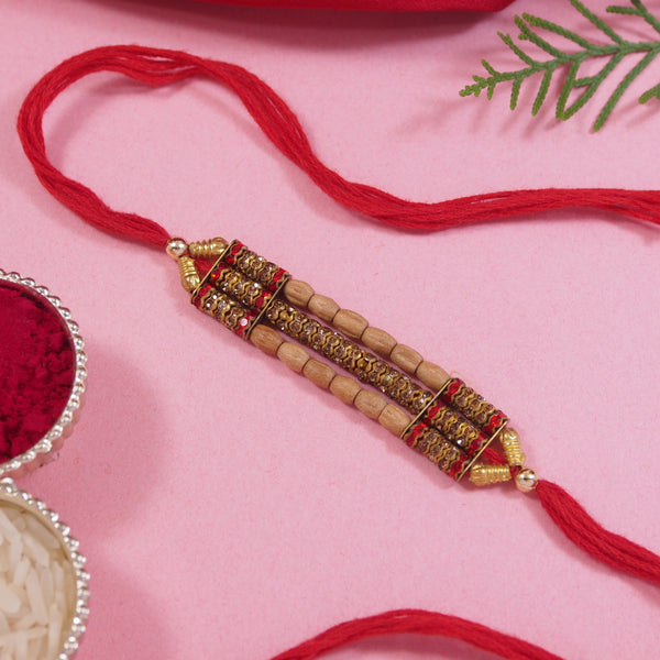 DELICATE PEARL BEADED MAROON RAKHI WITH ROLI CHAWAL & RAKSHABANDHAN CARD