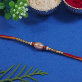 DELICATE PEARL BEADED RAKHI WITH ROLI CHAWAL & RAKSHABANDHAN CARD