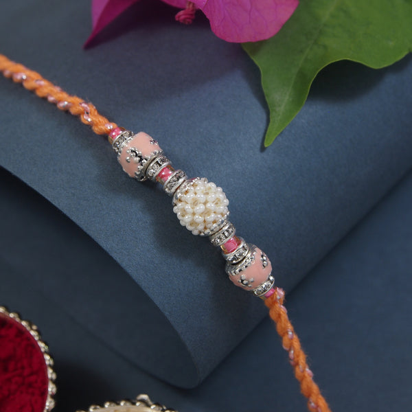 DELICATE PEARL BEADED Orange RAKHI WITH ROLI CHAWAL & RAKSHABANDHAN CARD